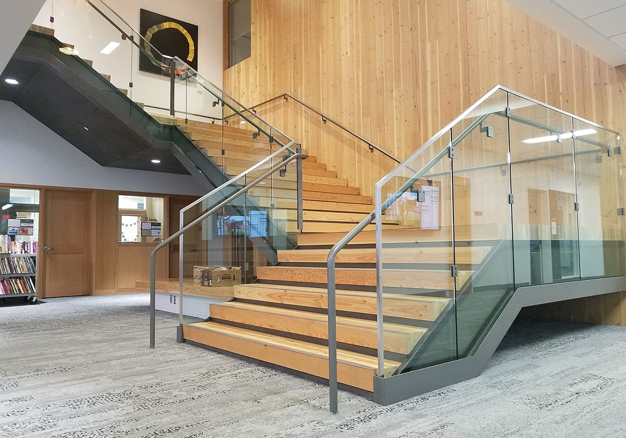 The interior of a library showcasing the architectural steel fabrication of stairs created by Instafab.