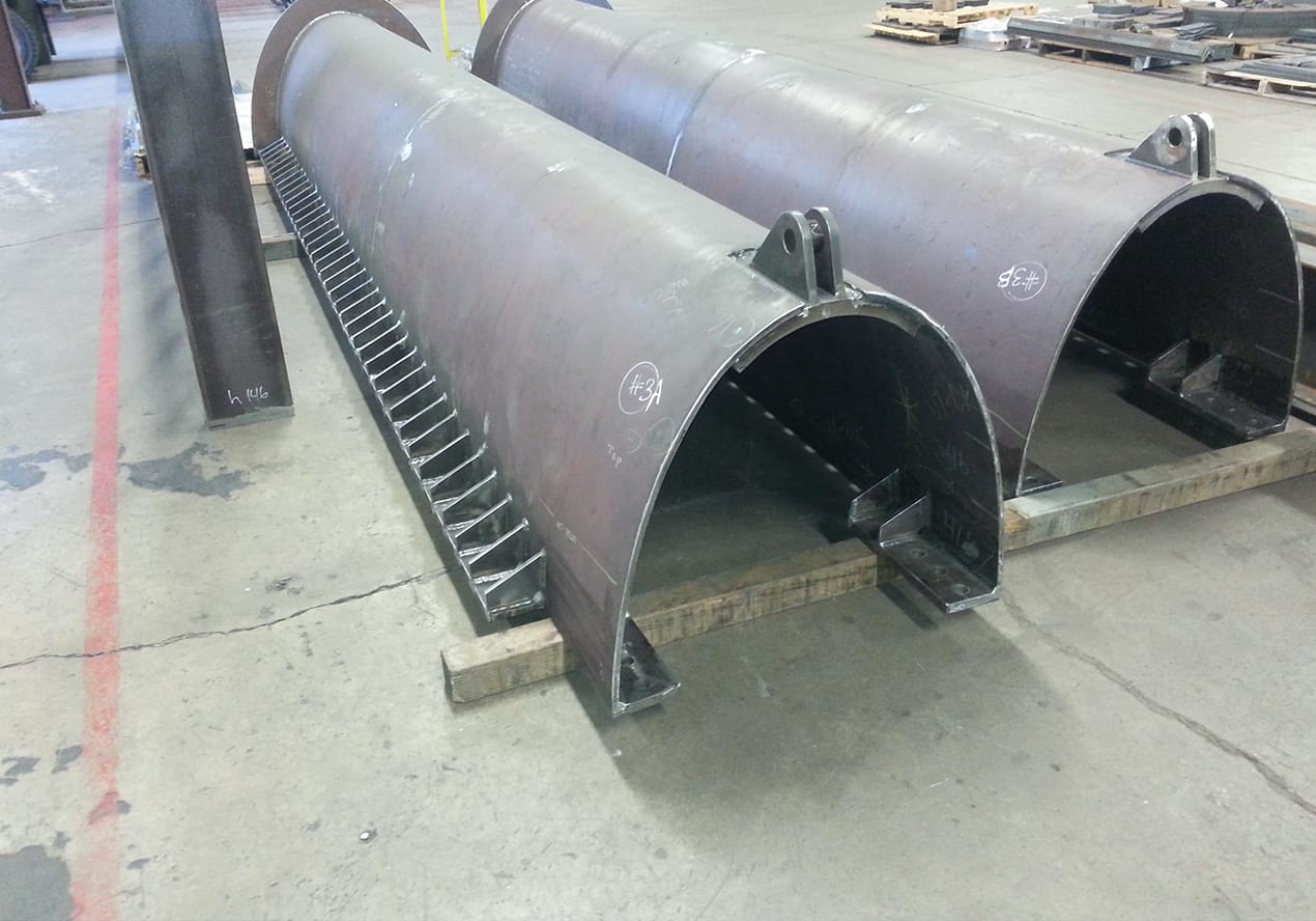 Large metal hollow pipes sit on the floor of Instafab's Vancouver, Wa warehouse.